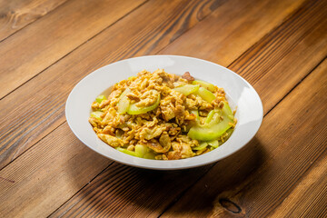 Watermelon scrambled eggs and ingredients on wooden background