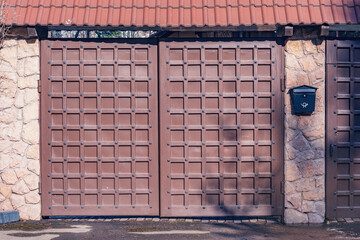 Wooden new gate by the house.