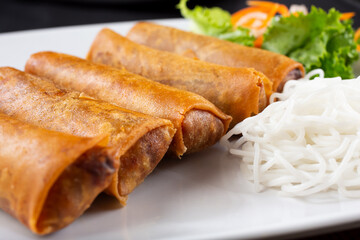 A view of a plate of egg rolls.