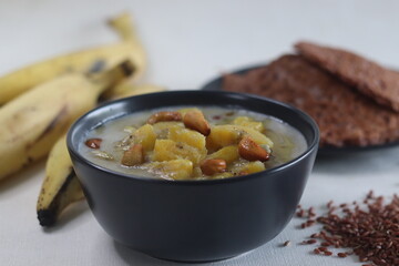 Ripe plantain stew. A sweet curry made of ripe plantain, coconut milk and seasoned with roasted cashews. Served with red rice pancakes