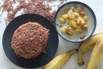 Red rice pancakes. Pancakes made of a fermented batter of red rice and coconut. Served with Ripe plantain stew © Trending Now