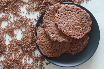 Red rice pancakes. Pancakes made of a fermented batter of red rice and coconut.