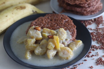 Red rice pancakes. Pancakes made of a fermented batter of red rice and coconut. Served with Ripe plantain stew