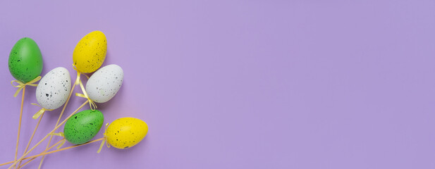 Top view photo of easter decorations easter eggs on isolated pastel lilac background with copy space. Easter composition for the cover.
