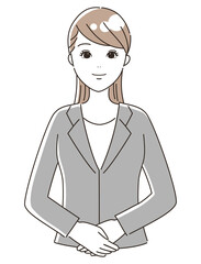 正面を向いて立っているスーツを着た女性（上半身）