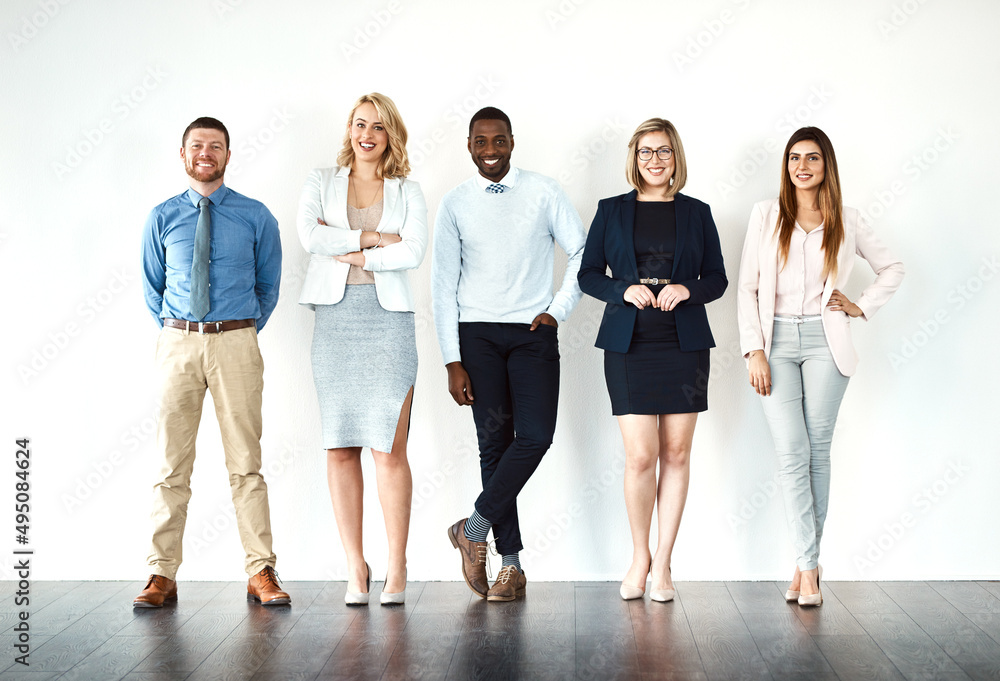 Leinwandbilder we call the shots. portrait of a group of work colleagues standing in a line while using their wirel