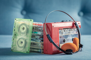 Transparent audio cassette with red player and headphones.