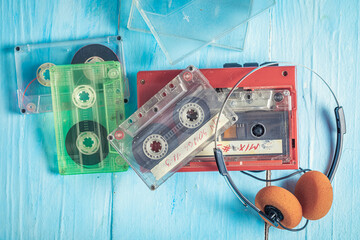 Vintage audio cassette with red player and headphones.