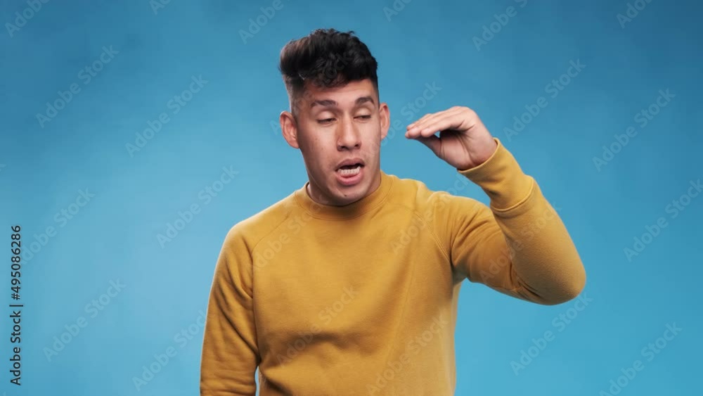 Aufkleber man showing bla bla gesture while standing against an isolated background.