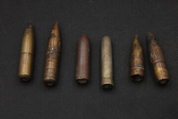 Old rifle bullets on black background