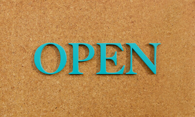 Open. Word in capital letter against a brown cork-board. Announcement and message. 3D illustration