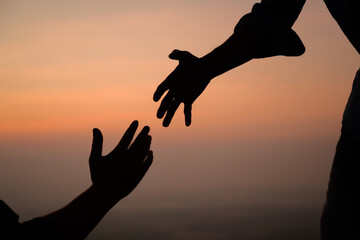 two people silhouettes about reaching out to help each other concept reaching out to help the nation of peace thanks for the support international day of peace develop friendship please help me