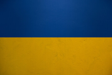 Ukraine flag background in blue and yellow from plaster wall texture pattern