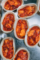 Tomato soup with meat chunks served in bowl made with bread dough. Food catering buffet.