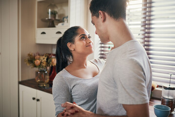 He knows just how to make my heart skip a beat. Cropped shot of a happy young couple slow dancing in their kitchen.