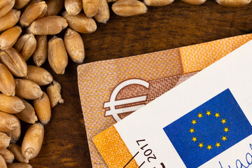 Wheat grains with details of 50 EUR banknote. Object lit with a uniform, soft light.