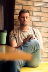 Man using smartphone in cafe.Man  relaxing in  cafe .