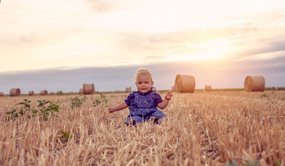 happy baby girl on field of wheat © Lucky Fenix