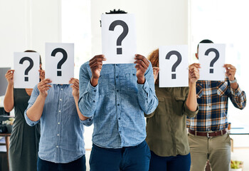 If you dont ask you dont get. Shot of a group of businesspeople holding questions marks in front of their faces.
