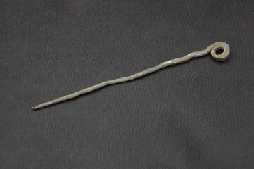Antique bronze hairpin on black background