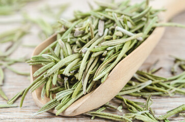 Fototapeta premium Dried rosemary spice in wooden spoon.