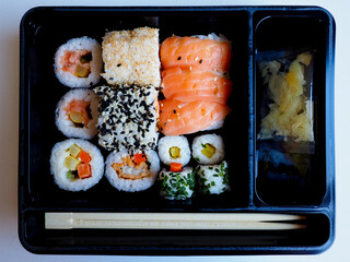 close up photo of a pack of takeout sushi rolls 