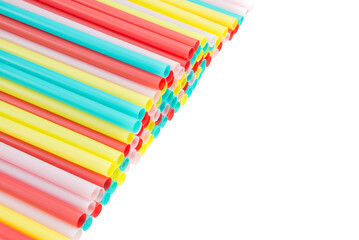 Colorful pastel plastic straws on white background with copy space. Drink equipment, celebration party concept.