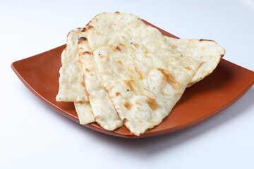 naan served in a plate, it's a type of Indian bread or roti roti/naa/tandoori/Indian bread