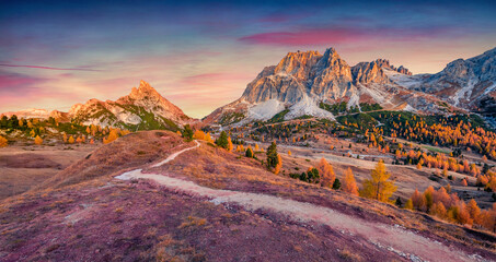 Fantastic sunrise on Falzarego pass with Forcella and Sass de Stria peaks on background. Attractive morning scene Dolomite Alps, Cortina d'Ampezzo lacattion, Italy, Europe.
