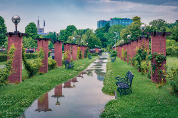 Puddles after rain in King Mihai I of Romania Park (Herastrau Park). Picturesque summer cityscape of Bucharest, capital of Romania, Europe. Traveling concept background.