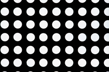 Black and white abstract texture background: Black lattice with round holes. Venting, ventilation with geometric circles pattern. Close up view.