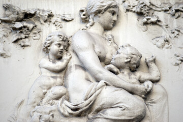 Fototapeta na wymiar A sandstone relief showing a naked woman breastfeeding her child. 