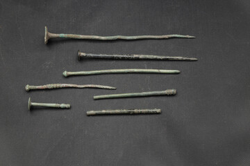 Antique bronze hairpin on black background