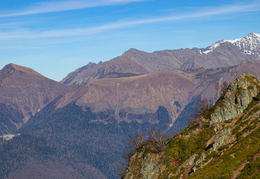 Beautiful landscape in the mountains with peaks against the blue sky and valleys covered with grass