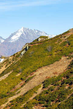 Beautiful landscape in the mountains with peaks against the blue sky and valleys covered with grass