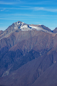Beautiful landscape in the mountains with peaks against the blue sky and valleys covered with grass