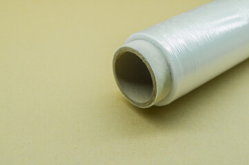 Roll of food stretch film for food packaging. Packaging film in a roll on a cardboard spool. Selective focus
