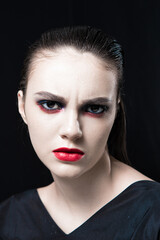 Creative Beauty Portrait with Red Lips and Blue Eyes on a Black Background 