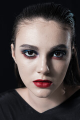 Creative Beauty Portrait with Red Lips and Blue Eyes on a Black Background 