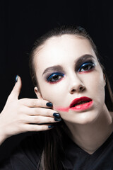 Creative Beauty Portrait with Red Lips and Blue Eyes on a Black Background 