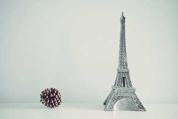 Eiffel tower model on white wall background copy space. Travel in Europe concept.