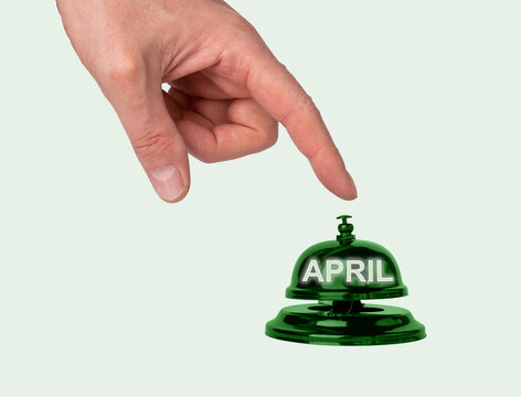 April, starting spring month. Hand, finger pressing button. High quality photo