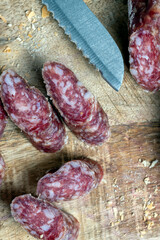 sliced pieces of sausage from meat are lying on a cutting board