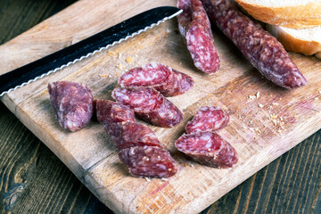 sliced pieces of sausage from meat are lying on a cutting board