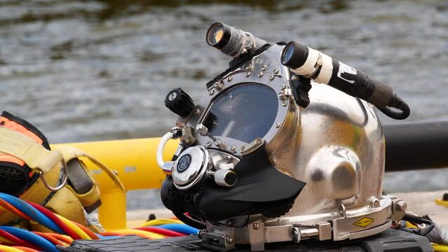 Professional diver working underwater with welding tools. Deep sea diving equipment, underwater engineering works.