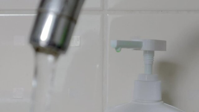 Close-up of drinking tap water flowing from a faucet. Designing a faucet in the kitchen or bathroom. The concept of water saving and water consumption, tariff and price of water.