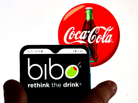 In This Photo Illustration, The Bibo, Fruit Punch Available In Turkey, South Africa, Mozambique, And Canada Logo Is Displayed On A Smartphone Screen With A Coca-Cola Logo In The Background