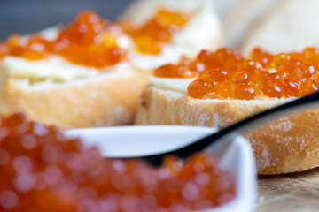 Naklejka na ściany i meble red salmon or trout caviar with white baguette and butter