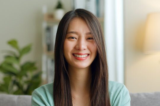 Portrait Of Young Asian Woman Look At Camera And Smile At Home.