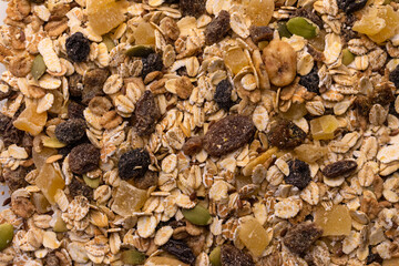 Muesli background with berries, nuts and candied fruits.